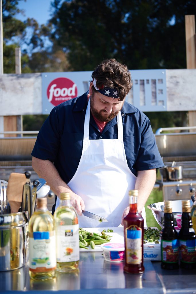 Finalist Jay Ducote preparing his dish, Grilled Ribeye with Basil Pomegranate Pesto & Stewed Okra with San Marzano Tomatoes, during the Star Challenge, July 4th Cookout, as seen on Food Network Star, Season 11.