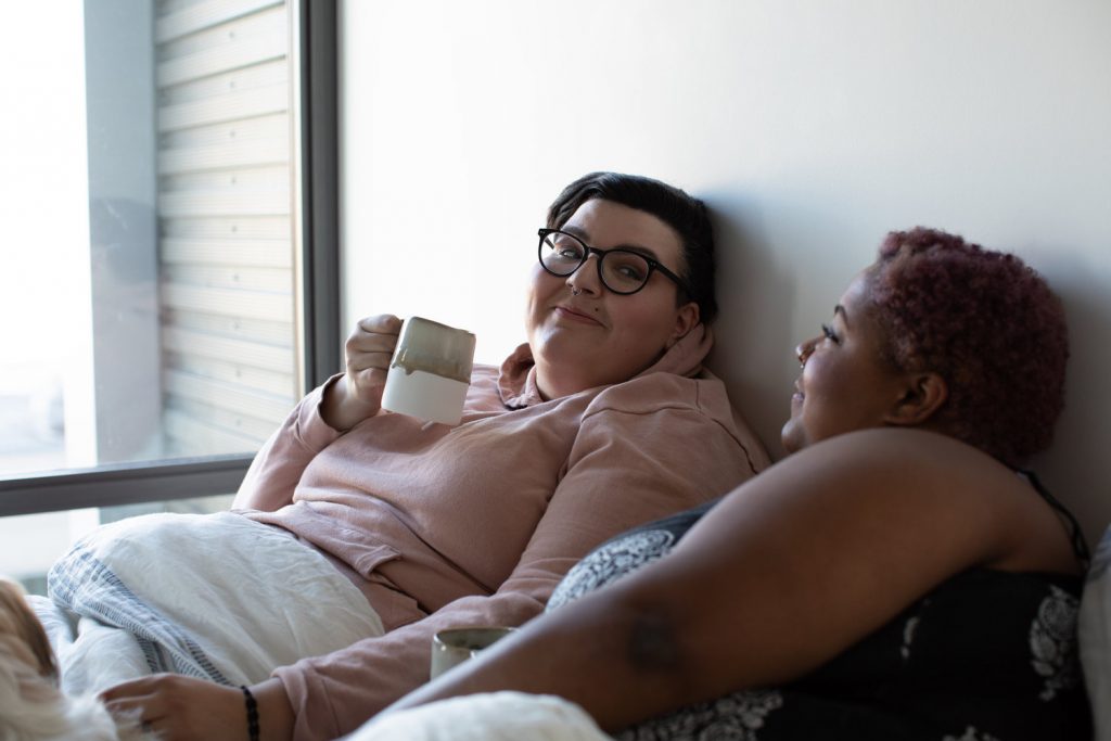 plus size couple in bed stock photos